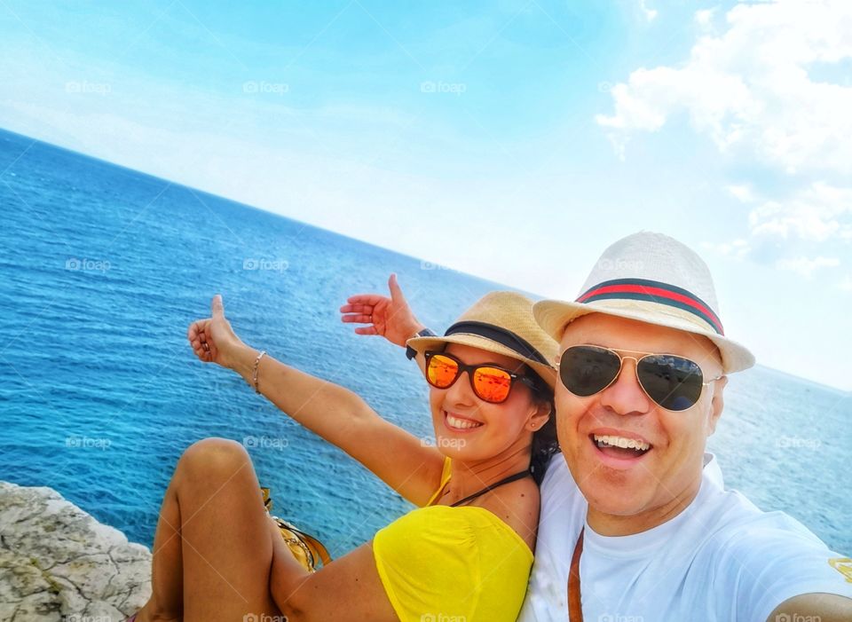 couple has fun and laughs on vacation by the sea