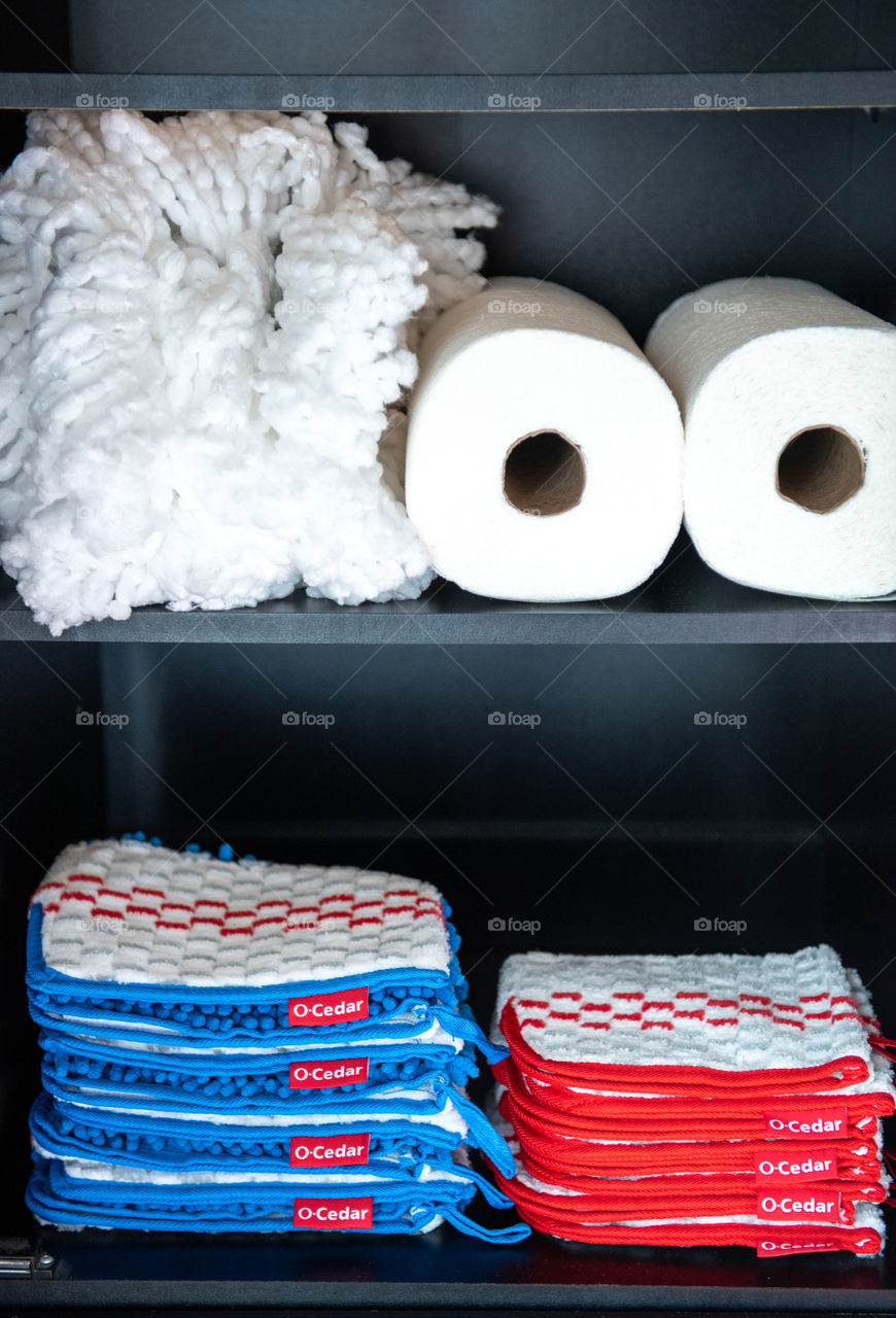 O-Cedar cleaning supplies stored in a cabinet