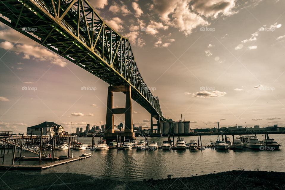 Tobin bridge passing over the water with boats underneath it 