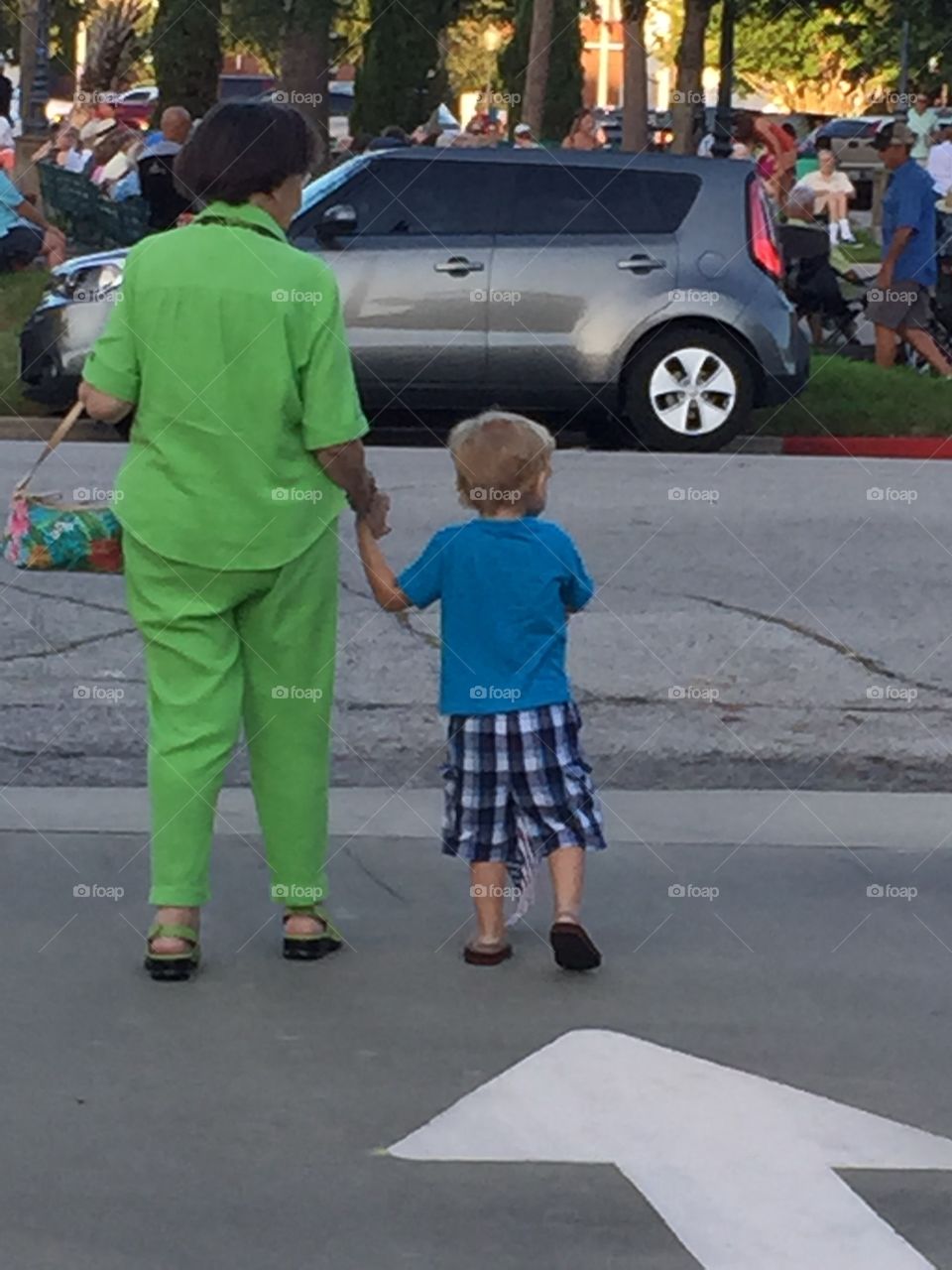 My Grandmother and nephew walking across the parking lot to go listen to the band concert in Galveston.