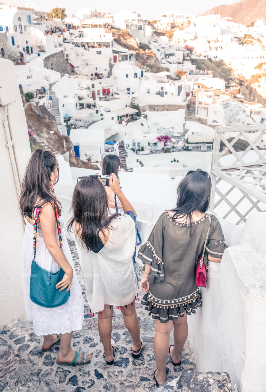 Tourist Girls Taking Photo With Camera In Famous Greek Island Santorini