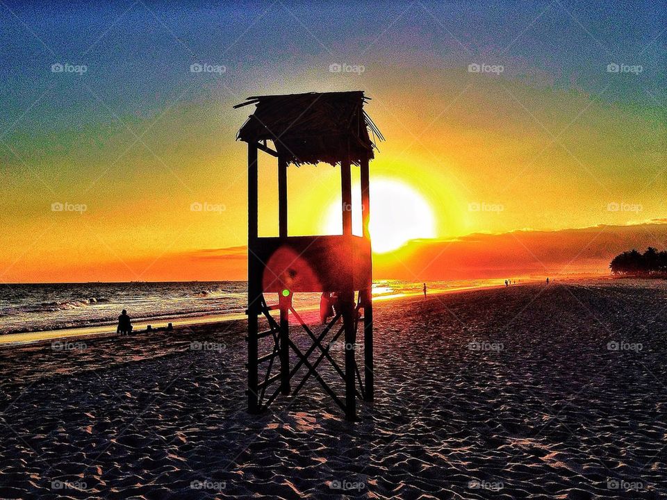 Life guard tower in sunset