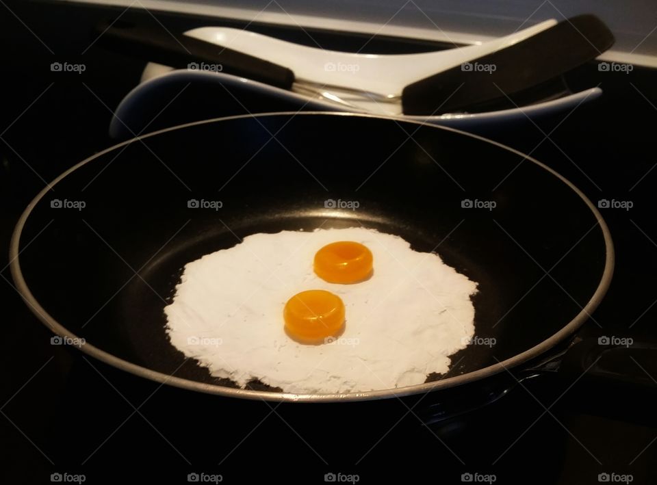 Faux fried eggs made of butterscotch and powdered sugar