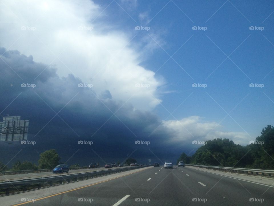 Clouds from rainstorm roll across a Florida highway.