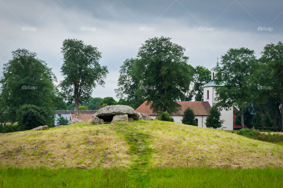 Megalithic stones in Slota. Ancient ritual burial grounds. Next to it church building. Sweden.