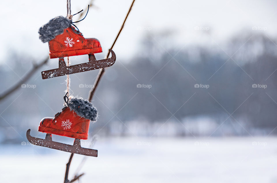 Vintage red skates on a white snowy background.