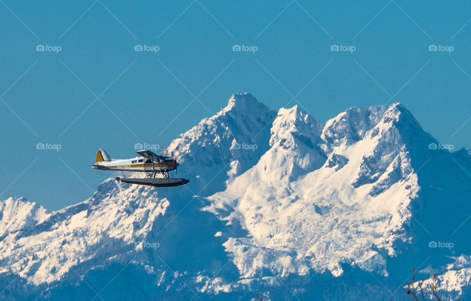 Airplane flying in front of mountain