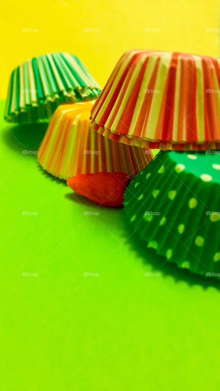 colorful cupcake liners on a green background