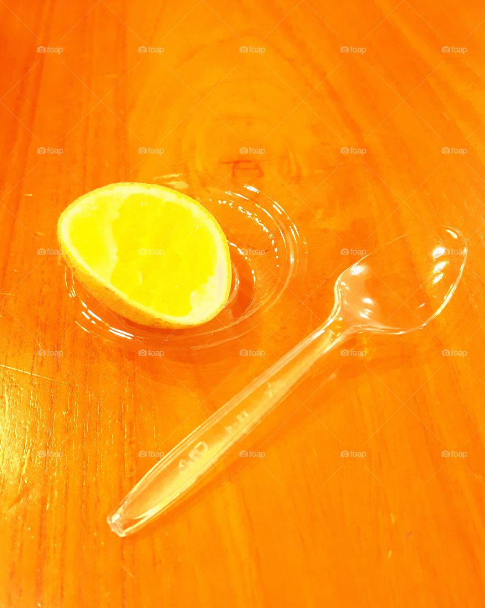 lime and a spoon on a wooden table