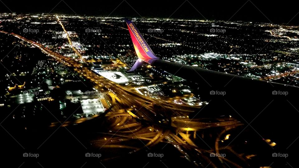 flying over the high five of Dallas Texas, astonishing view with a the lights showing from a far