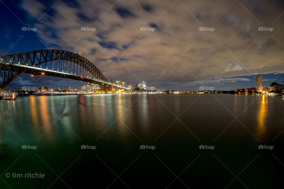 From Harry Seidler’s Blues Point Tower to the renovated Milson’s Point Ferry Wharf - Sydney Harbour before dawn with the flask of the lights from a train heading north over the bridge