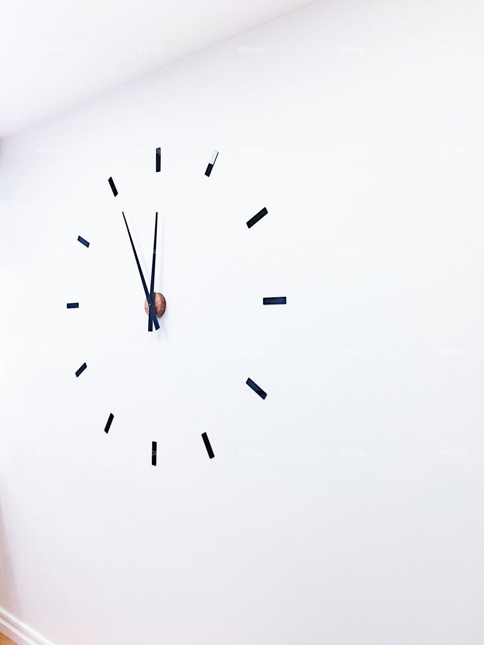 Five minutes until Midnight on a minimalistic wall clock