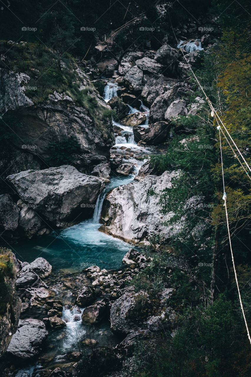 Mountain waterfall in the gorge among the rocks.