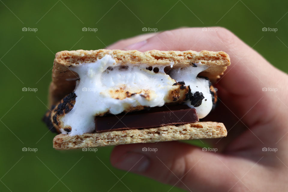 Child holding S'mores in her hand.