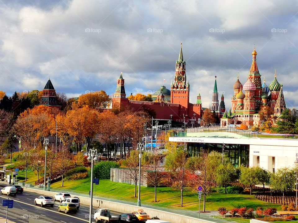 Moscow. View of the Moskvoretskaya Embankment, Zaryadye Park, the Moscow Kremlin, St. Basil's Cathedral and the Spasskaya Tower. Autumn trees