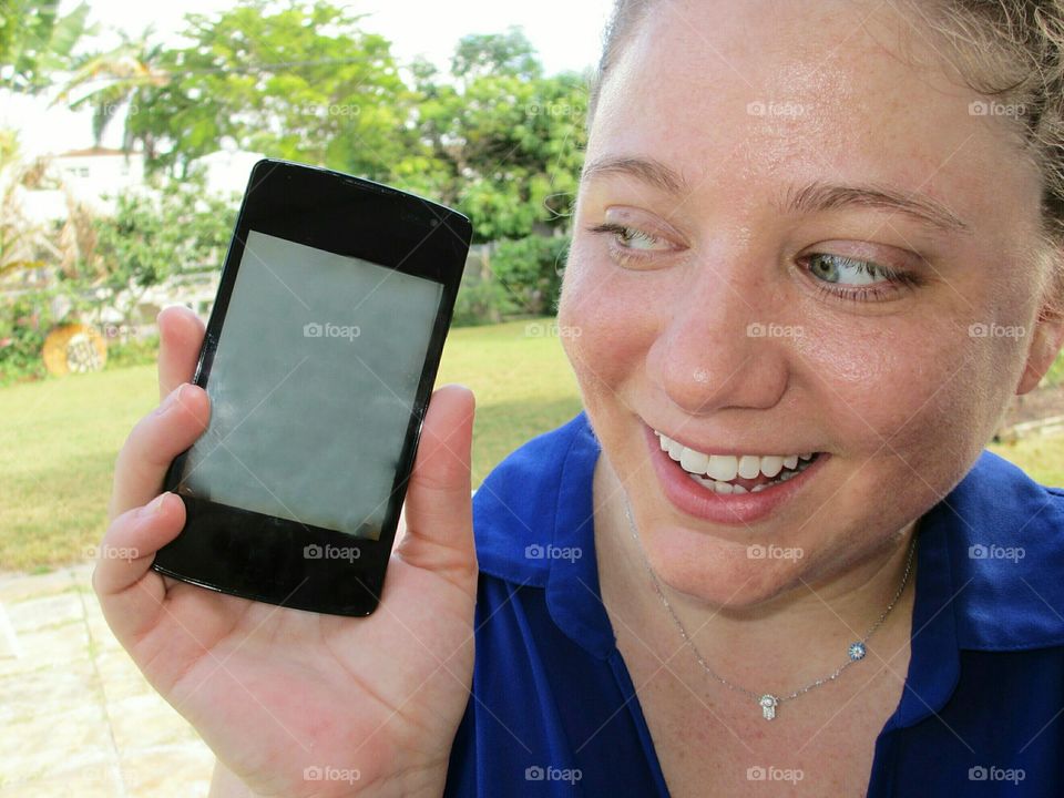 Close-up of woman holding smartphone