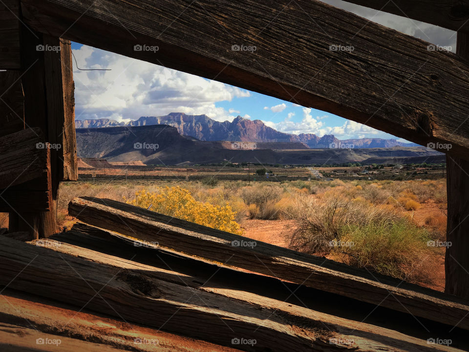 Utah red rock mountains viewed through cattle fence