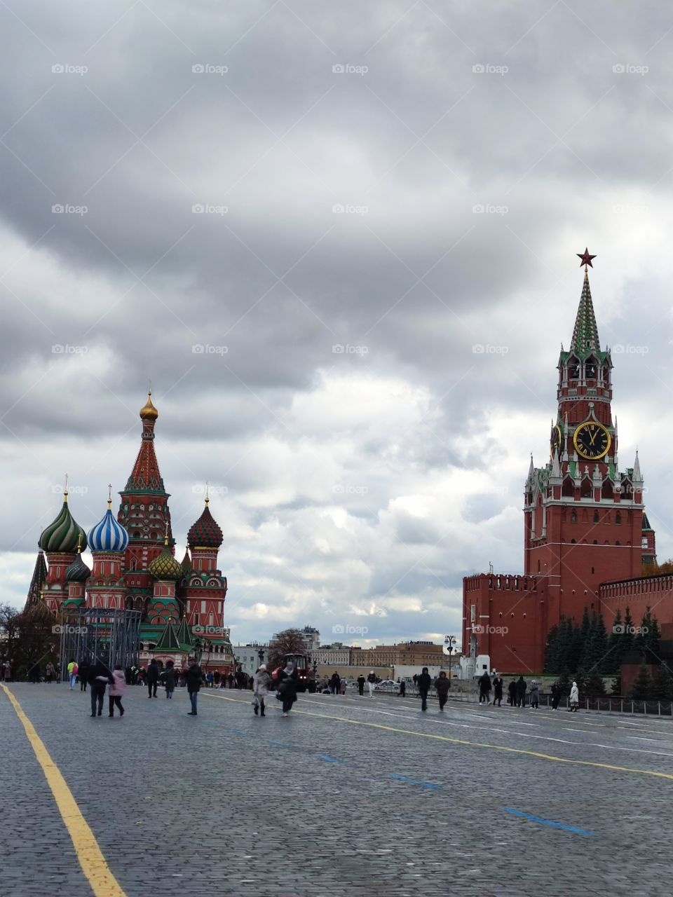 Moscow.  The Red Square.  St. Basil's Cathedral and the Spasskaya Tower with chimes.  Tourists