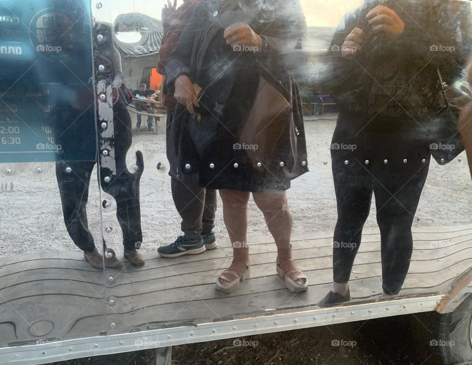 Reflection of queuing people in food truck 