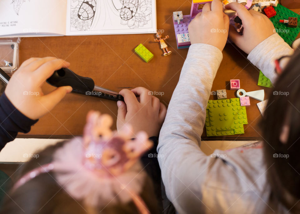 Two little girls building and constructing while playing