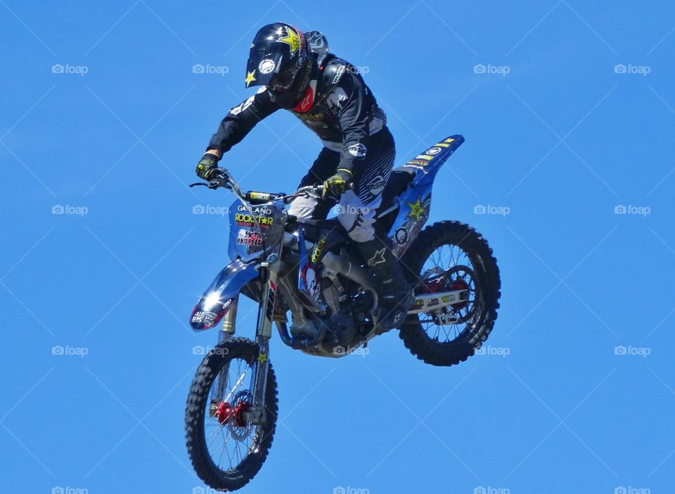 Motorcycle Stunt. Expert Rider Jumping A Motorcycle
