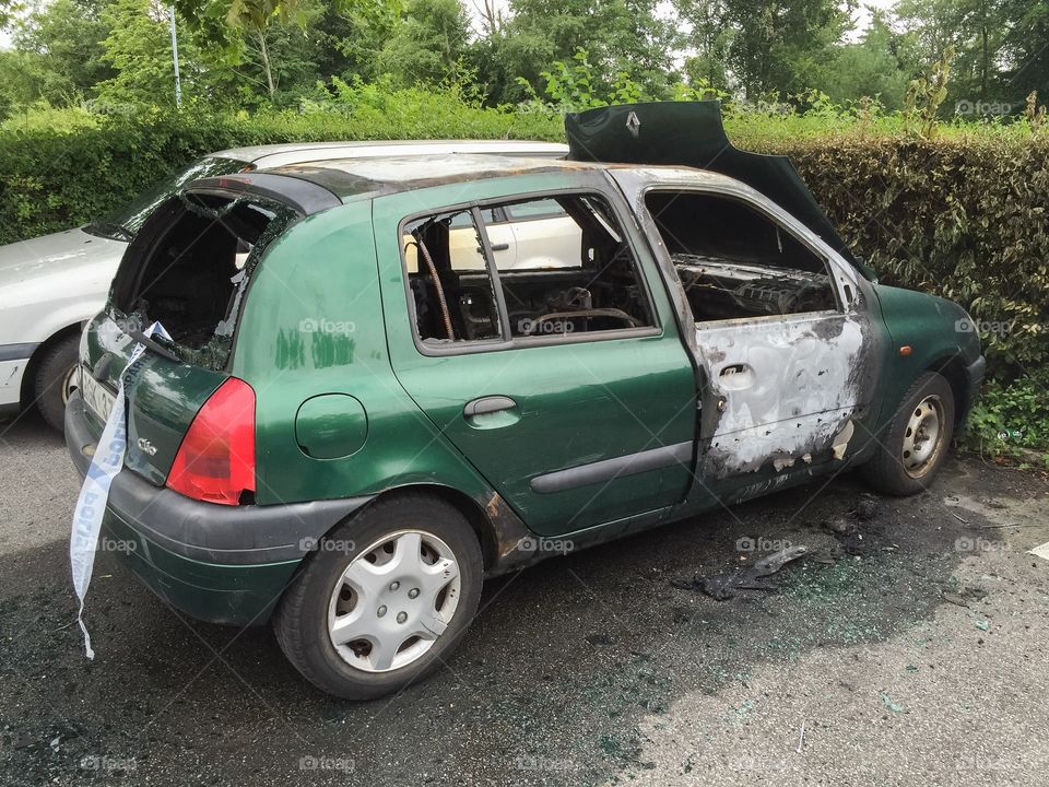 Burnt-out car in the affected area Kroksbäck in Malmö, Sweden. Youths set fire to cars at night.