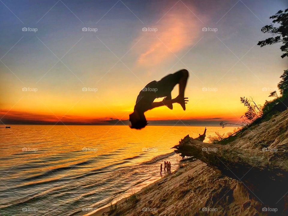 A back flip in the Michigan sand dunes at sunset