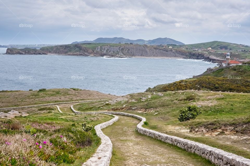 Panoramic view of Comillas coast and its lighthouse, Spain