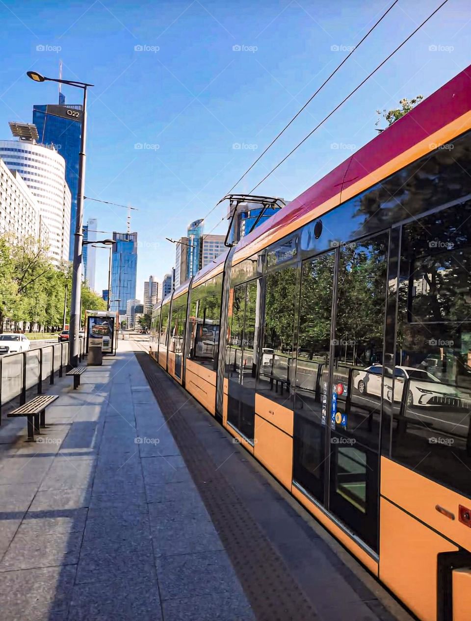 Tram on Modern Street with City Buildings Background