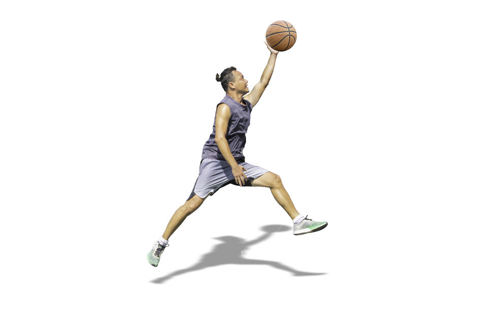 Isolated Basketball in hand man jumping on a white background with clipping path.