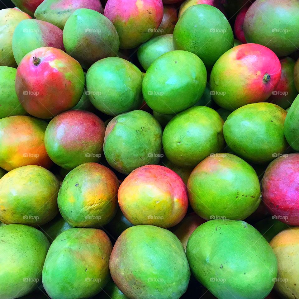 A lovely collection of colorful mangoes .