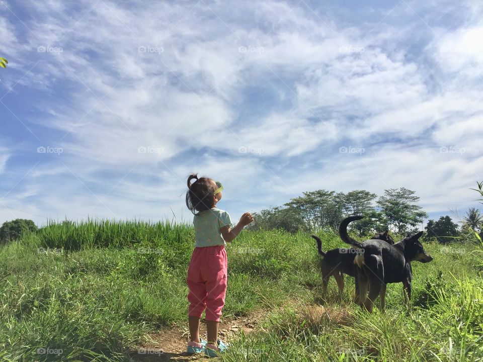 Toddler girl with her doggy 