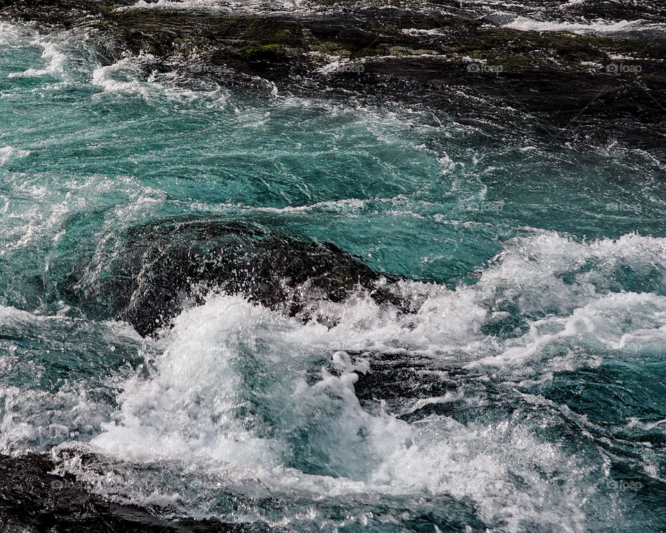 Water breaks on the rocks at Wizard Falls on the Metolius River in Central Oregon. 