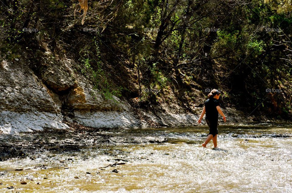 Girl walking along the rocks