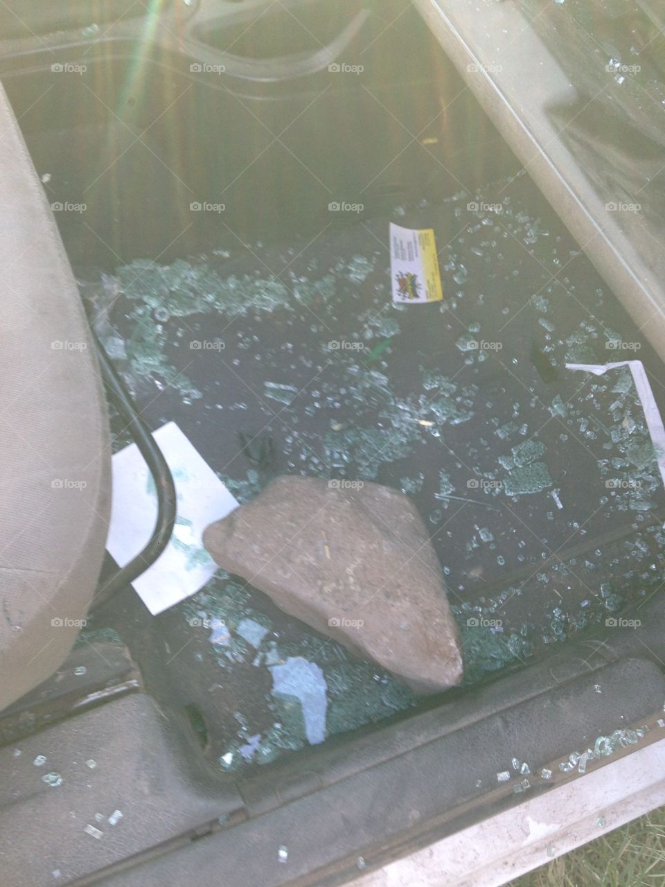 Broken car window with stone