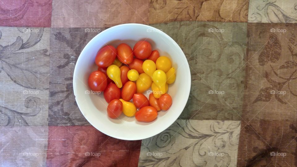 Red and Yellow pear tomatoes on table cloth