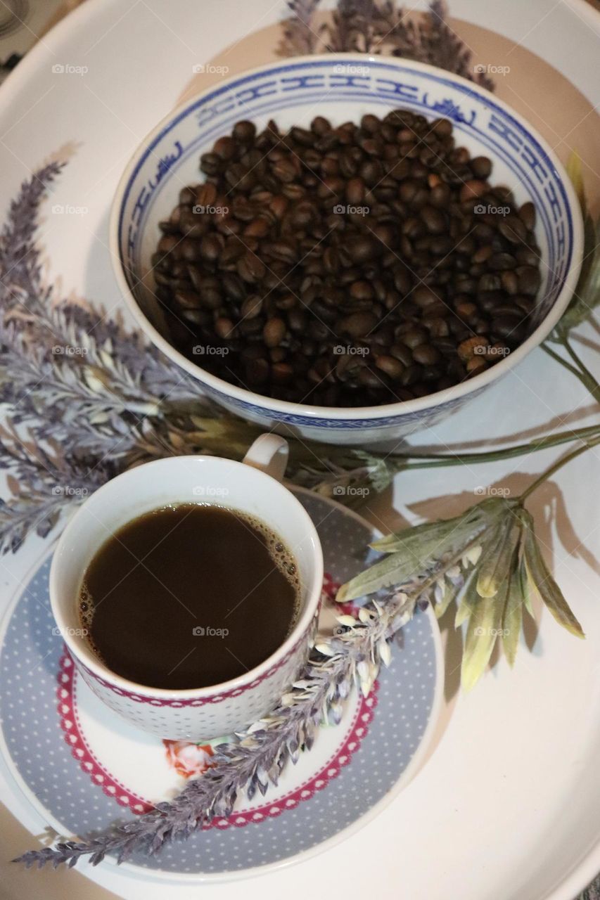 A cup of coffee and coffee beans