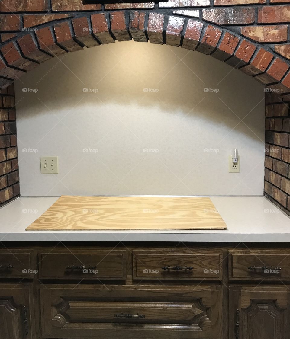 Brick surround in kitchen prior to cooktop installation