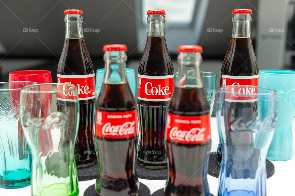 different bottles and glasses of Coca Cola