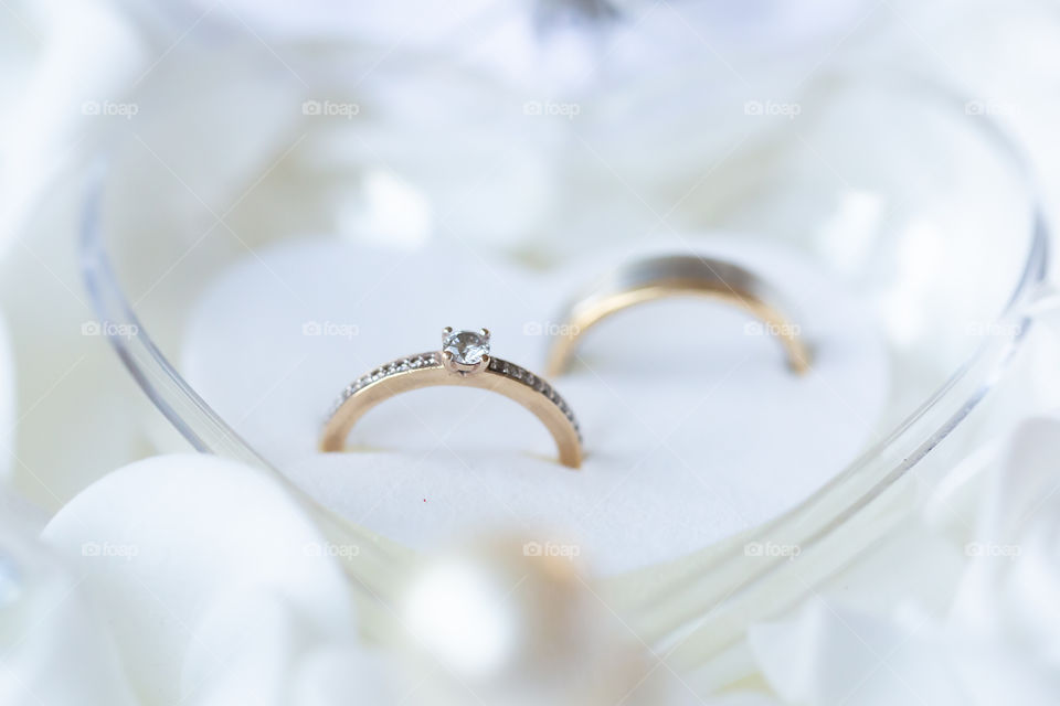 Close-up on beautiful wedding rings in a heart-shaped box 