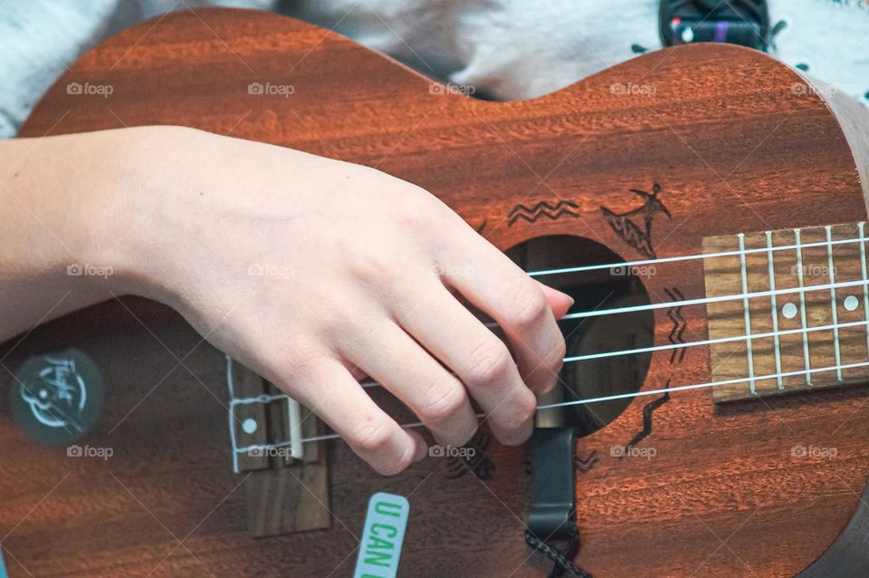 Girl playning on ukulele