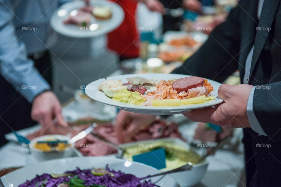 Food buffet, people taking food. Christmas buffet is a swedish tradition at christmas.