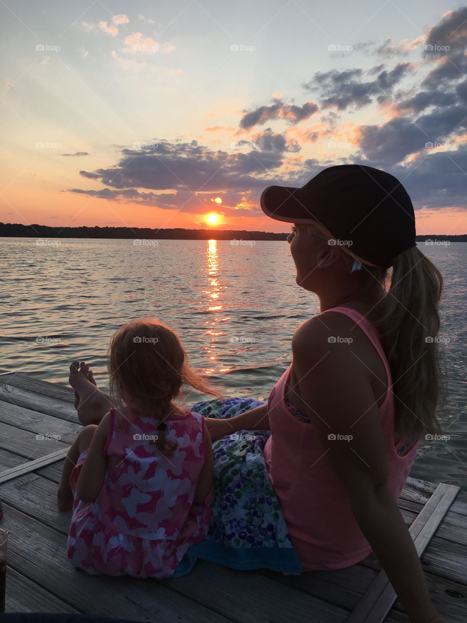 Mom and daughter watching a beautiful Michigan sunset 