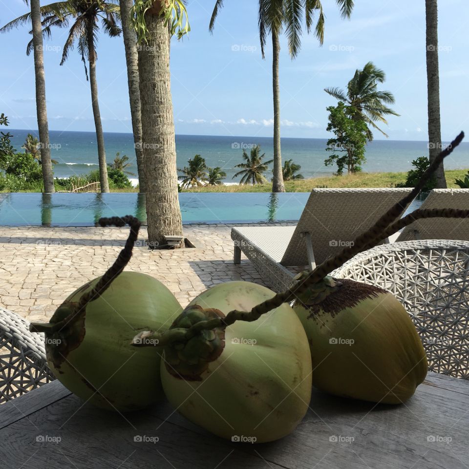 Three coconuts on a beach in Bali