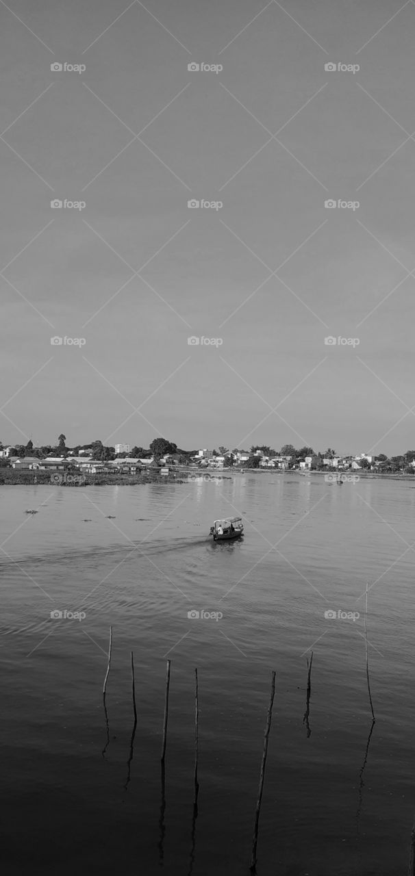 A small boat run out in the large river