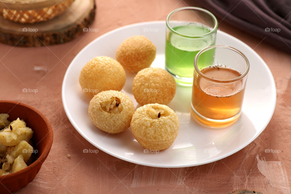 Indian food snack gol Gappe or Pani Puri or Puchka in a white bowl