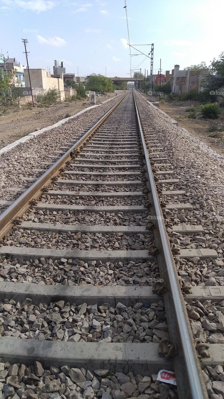 railway track, parallel to each other, grit in between the track, cement slipper,use for public and transportion,a way to go forward