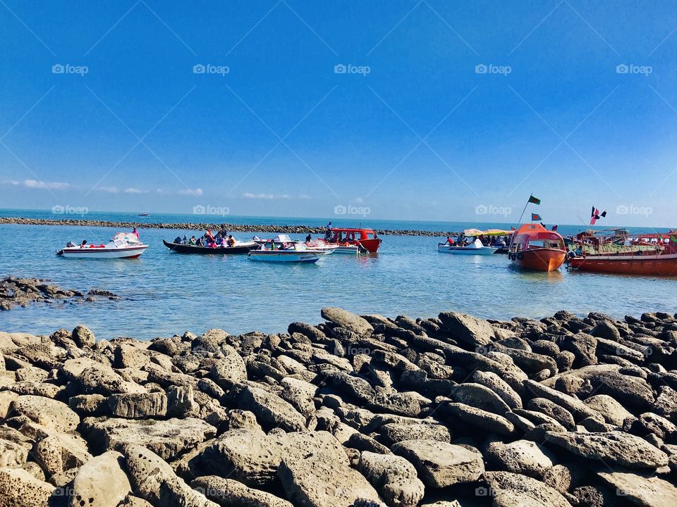 Traveling a wonderful spot, really a nice view to watch.    Blue ocean with blue sky, people are also enjoying the beauties of nature ! 