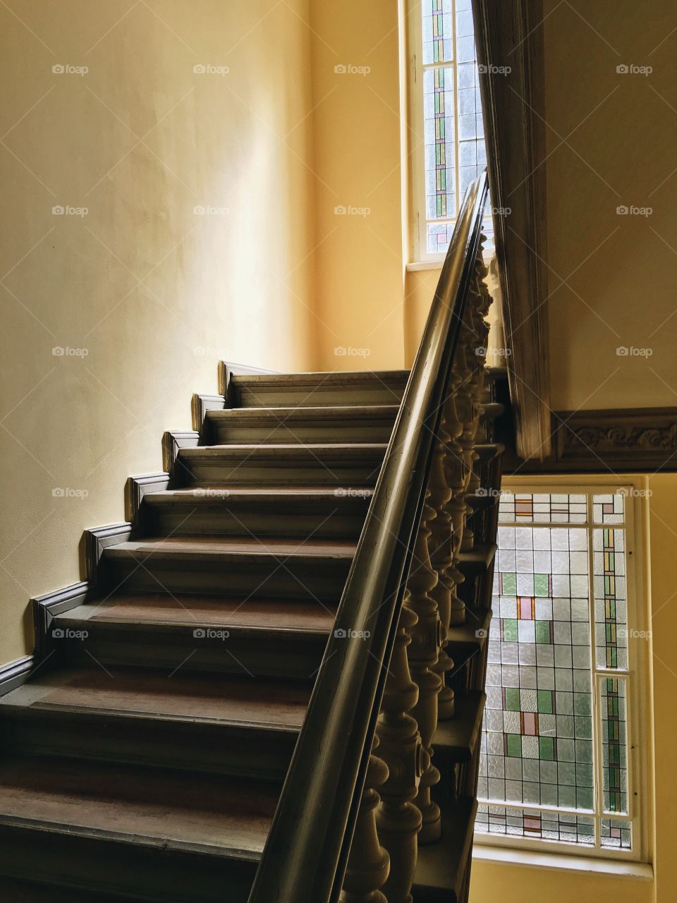 Stairway of mansion with light coming through window