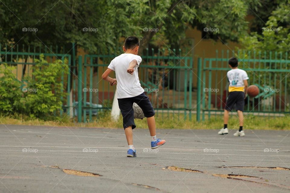 children in the old stadium play football.